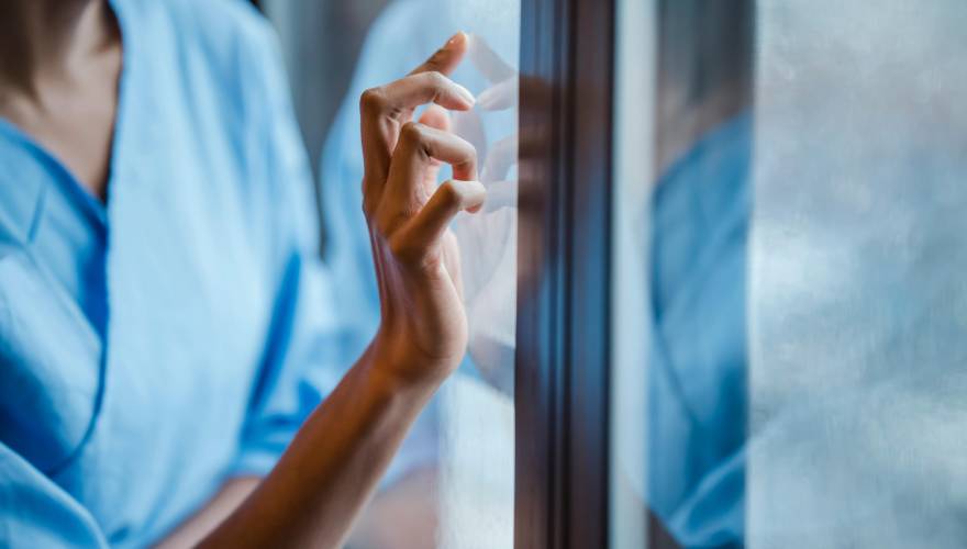 donna alla finestra di un ospedale